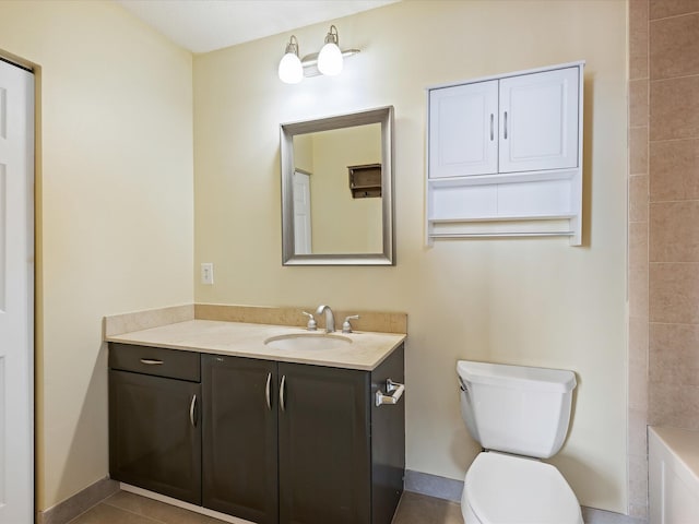 bathroom with tile patterned flooring, vanity, toilet, and a washtub