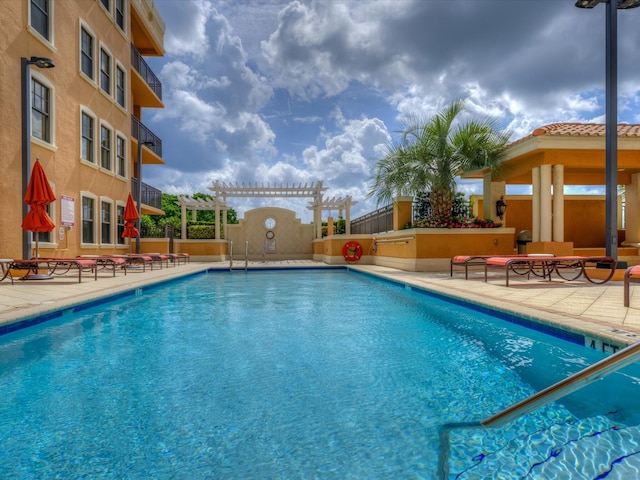 view of pool with a pergola and a patio