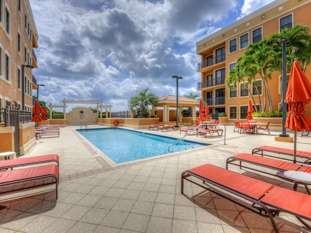 view of pool with a pergola and a patio