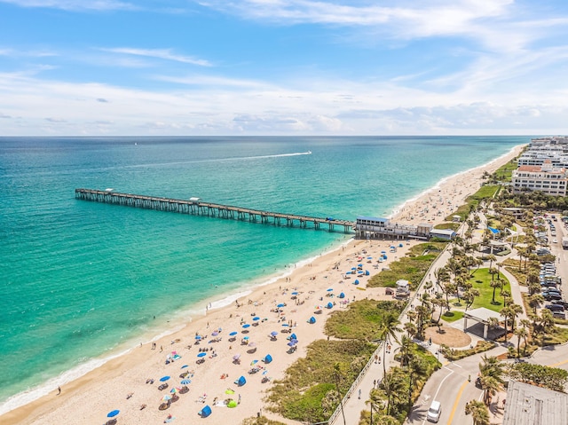 drone / aerial view featuring a water view and a beach view