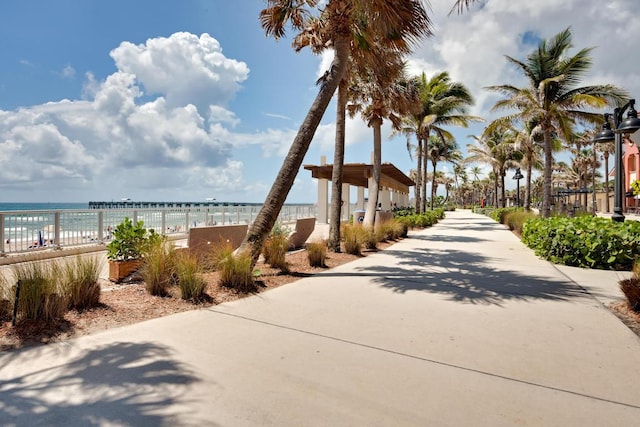 surrounding community featuring a water view and a view of the beach