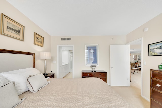 carpeted bedroom featuring ensuite bathroom