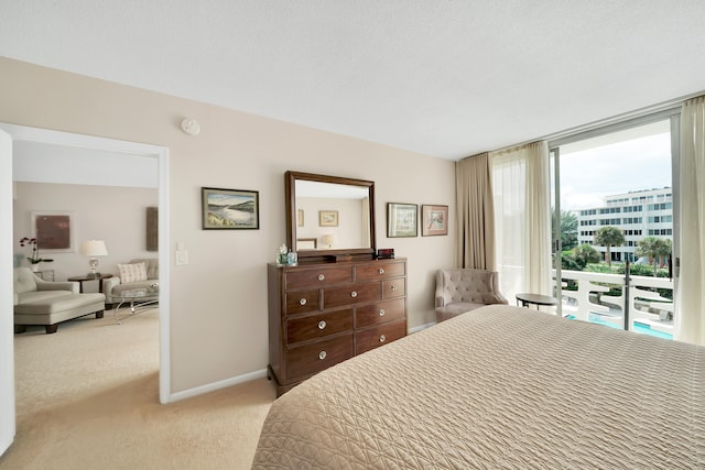 carpeted bedroom with access to outside and a textured ceiling