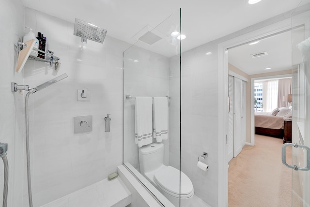 bathroom featuring toilet and an enclosed shower