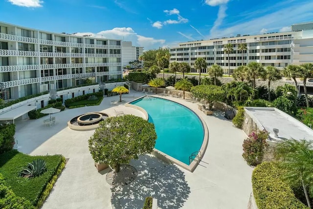 view of swimming pool with an outdoor fire pit and a patio