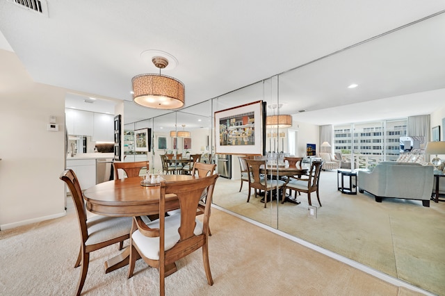 dining room with light colored carpet