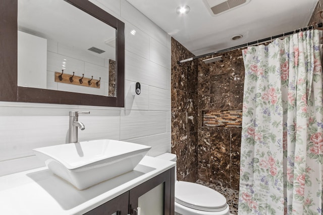 bathroom featuring vanity, toilet, tile walls, and walk in shower