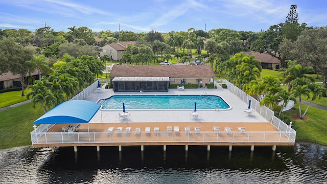 exterior space featuring a water view, a lawn, and a patio