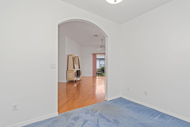 empty room featuring hardwood / wood-style floors and ceiling fan