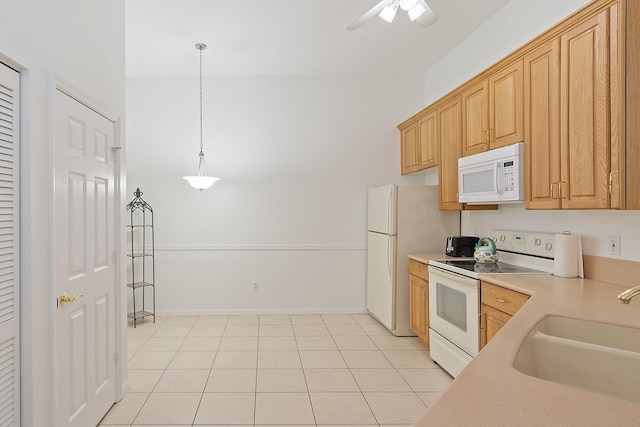 kitchen featuring white appliances, sink, ceiling fan, hanging light fixtures, and light tile patterned flooring