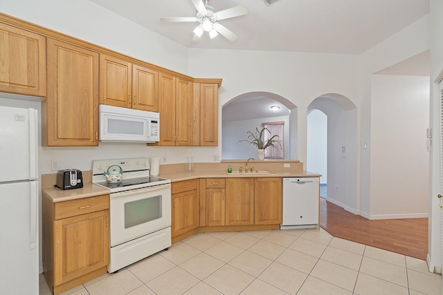 kitchen featuring white appliances, light hardwood / wood-style flooring, sink, ceiling fan, and lofted ceiling