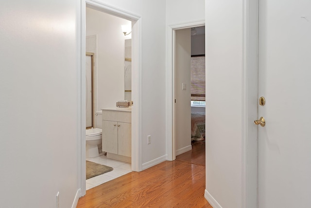 hallway with light hardwood / wood-style flooring