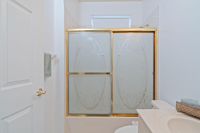 full bathroom featuring shower / bath combination with glass door, toilet, and vanity