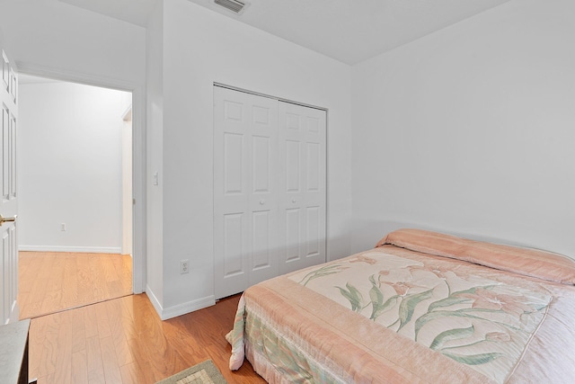 bedroom featuring a closet and light hardwood / wood-style flooring