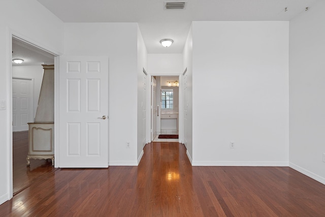 spare room featuring dark hardwood / wood-style flooring