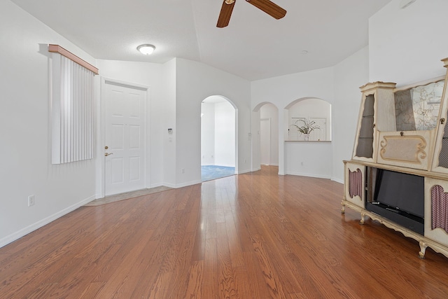 interior space featuring ceiling fan, vaulted ceiling, and hardwood / wood-style flooring