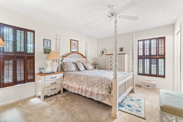 bedroom with a textured ceiling, ceiling fan, and carpet flooring