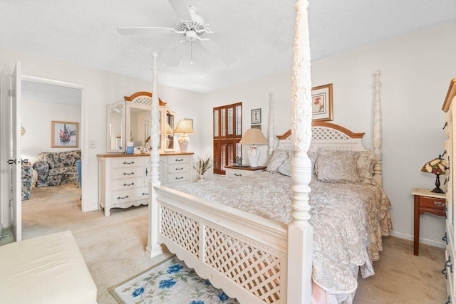 carpeted bedroom with a textured ceiling and ceiling fan