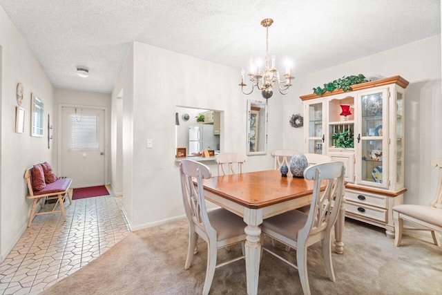 282 Cape Cod Cir Unit A, Lake Worth, FL 33467 - dining space with a chandelier, a textured ceiling, baseboards, and light colored carpet
