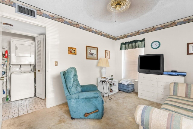 living room with light carpet, a textured ceiling, and stacked washer / drying machine