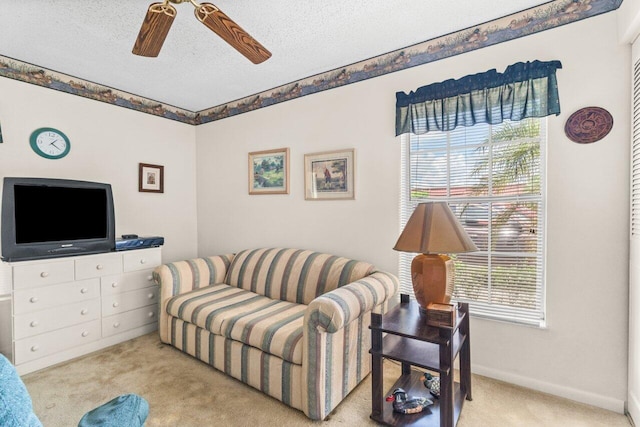 carpeted living room with a textured ceiling and ceiling fan