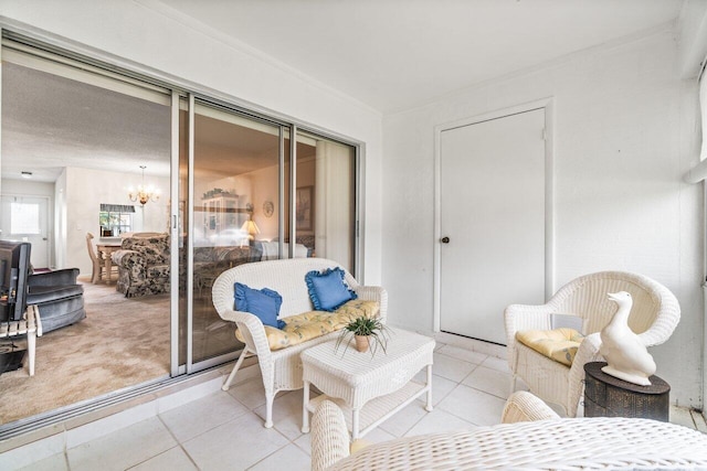 living area featuring light tile patterned floors and an inviting chandelier