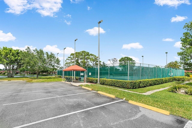 view of vehicle parking with a yard and a gazebo