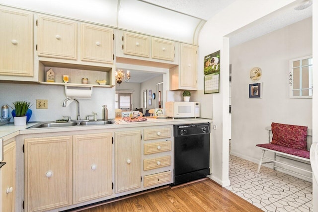 282 Cape Cod Cir Unit A, Lake Worth, FL 33467 - kitchen with black dishwasher, a sink, white microwave, light countertops, and light brown cabinetry