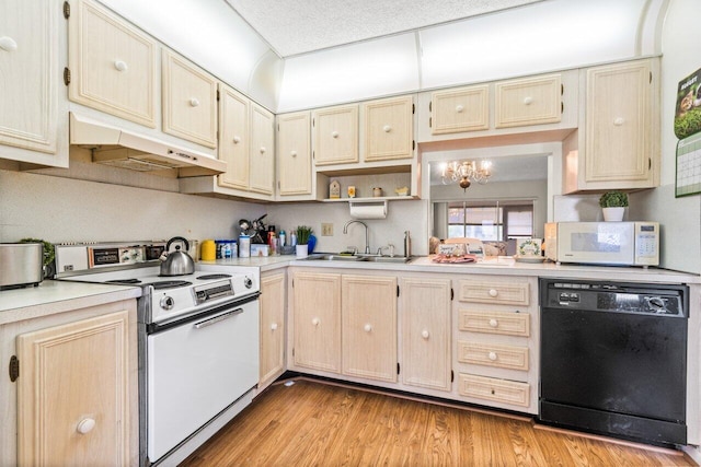 kitchen featuring white appliances, a chandelier, sink, and light hardwood / wood-style floors