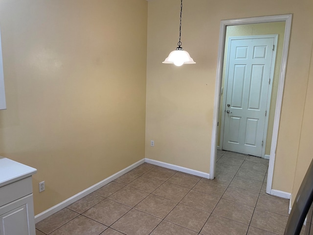 unfurnished dining area featuring light tile patterned floors