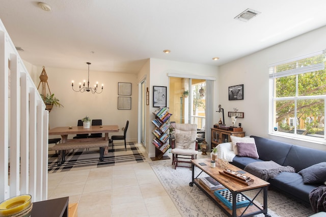 tiled living room featuring a chandelier