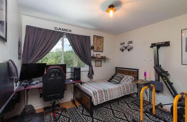 bedroom with hardwood / wood-style flooring