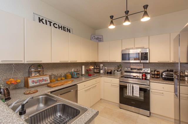 kitchen with light tile patterned flooring, sink, tasteful backsplash, decorative light fixtures, and stainless steel appliances