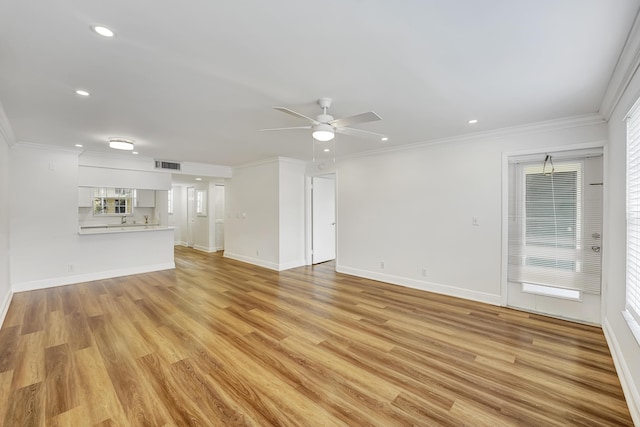 unfurnished living room with light wood-style flooring, crown molding, ceiling fan, and baseboards