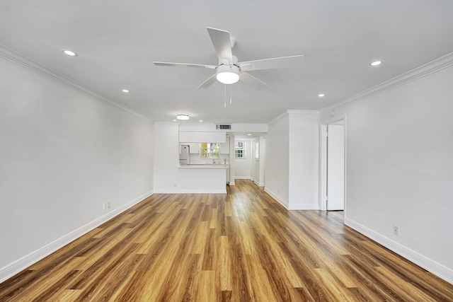 unfurnished living room featuring light hardwood / wood-style flooring, ceiling fan, and crown molding