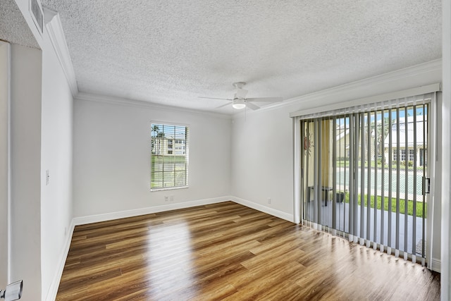 spare room with a textured ceiling, wood-type flooring, ornamental molding, and ceiling fan