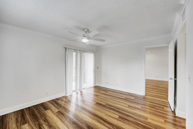 empty room with light wood finished floors, crown molding, ceiling fan, and baseboards