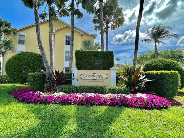 community / neighborhood sign with a yard