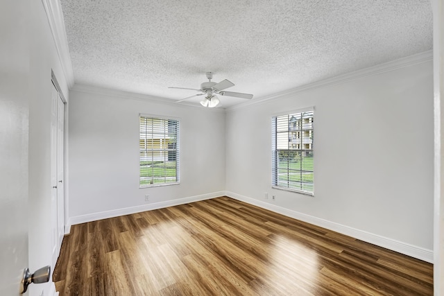 empty room featuring baseboards, ornamental molding, a textured ceiling, ceiling fan, and wood finished floors