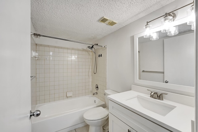 full bathroom with a textured ceiling, tiled shower / bath combo, vanity, and toilet