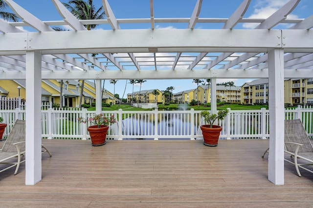 wooden terrace featuring a water view and a residential view
