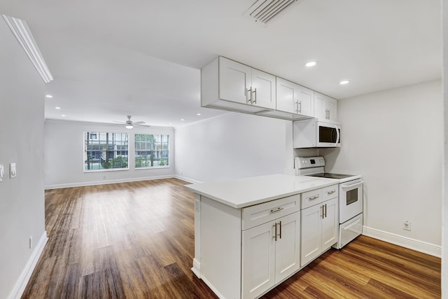 kitchen with baseboards, a ceiling fan, white appliances, white cabinetry, and wood finished floors