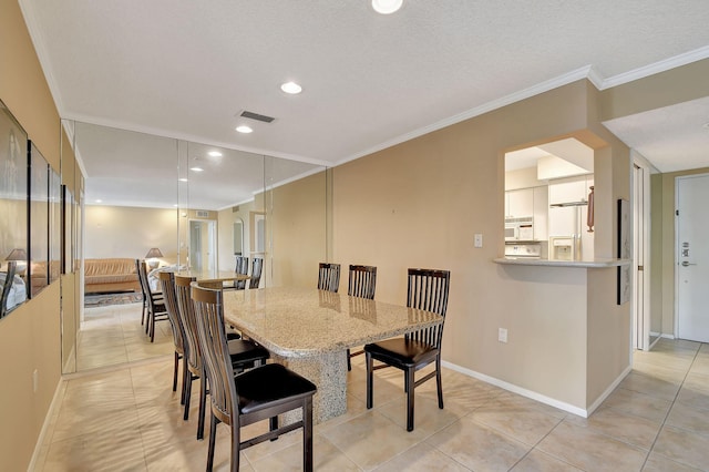 dining space featuring light tile patterned flooring and ornamental molding