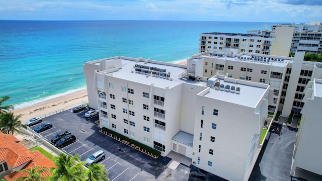 birds eye view of property featuring a beach view and a water view