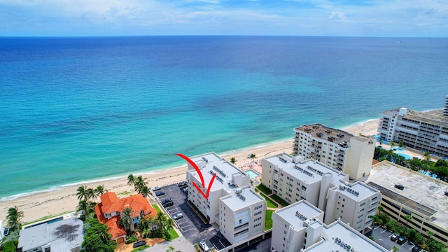 birds eye view of property with a beach view and a water view