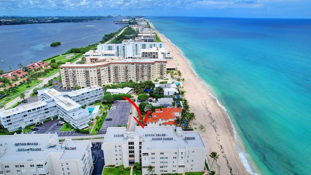 drone / aerial view featuring a beach view and a water view