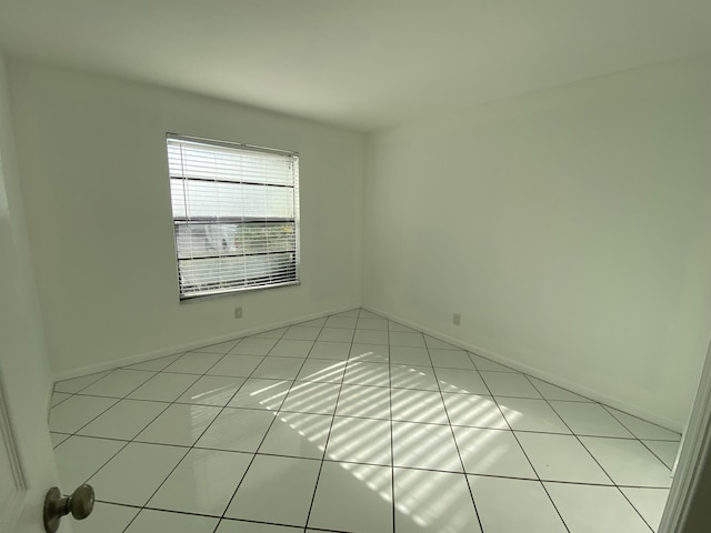 unfurnished room featuring light tile patterned floors