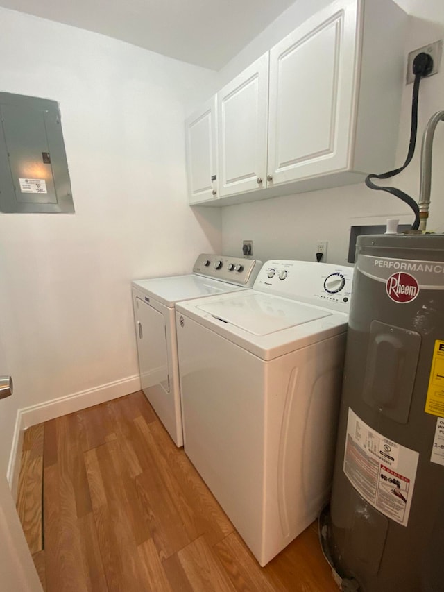 washroom with cabinets, water heater, independent washer and dryer, electric panel, and light hardwood / wood-style floors