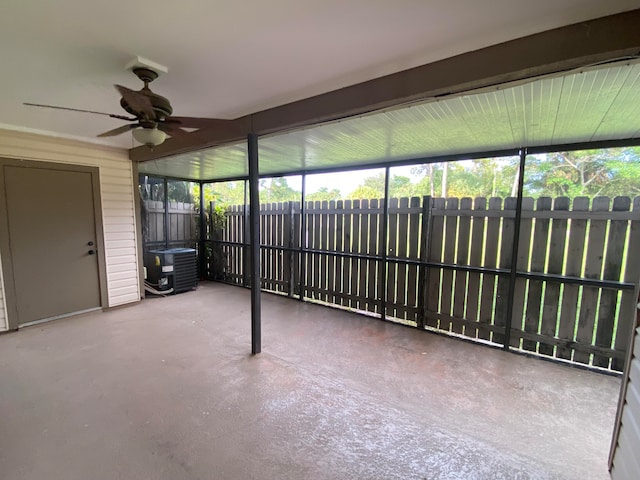 unfurnished sunroom featuring ceiling fan