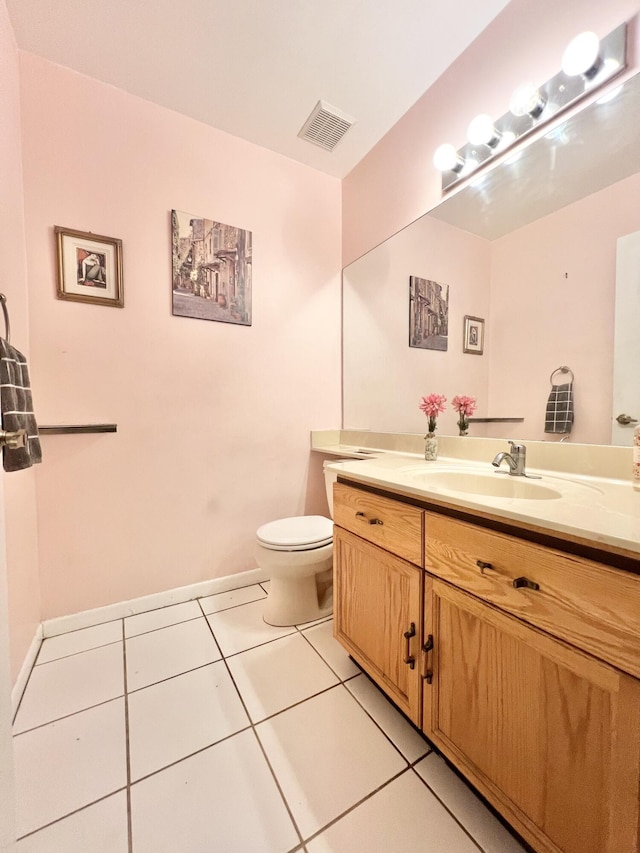 bathroom featuring toilet, vanity, and tile patterned flooring